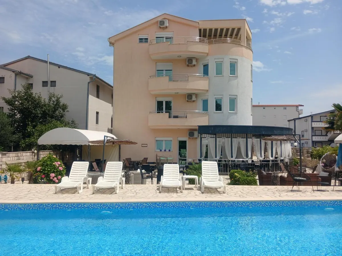 Guest house exterior viewed across the pool