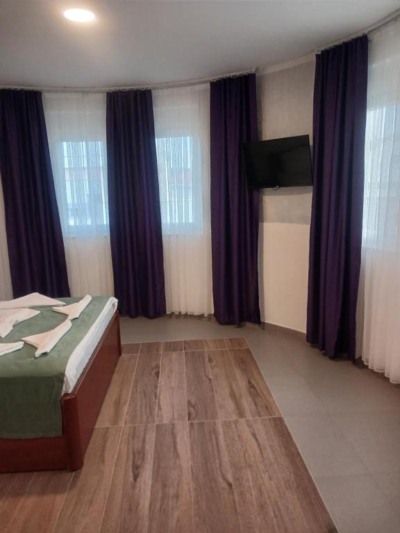 Guest room with two beds and a wall mounted flat screen television